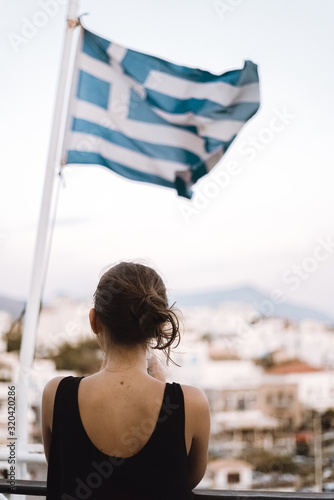 Girl on a ferry with flag of Greece