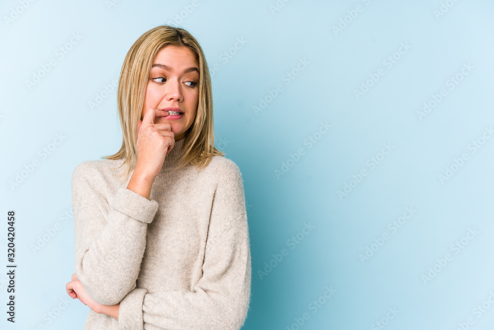 Young blonde caucasian woman isolated relaxed thinking about something looking at a copy space. Young blonde caucasian woman isolated relaxed thinking about something looking at a copy space.