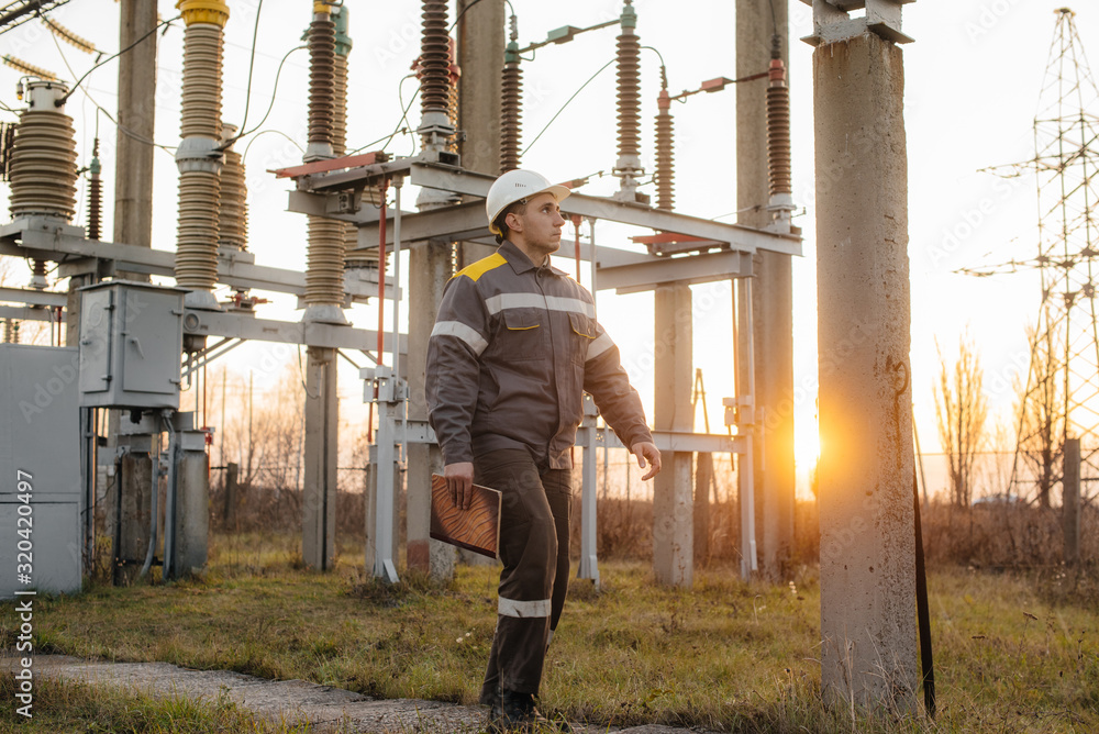 The energy engineer inspects the equipment of the substation. Power engineering. Industry The energy engineer inspects the equipment of the substation. Power engineering. Industry