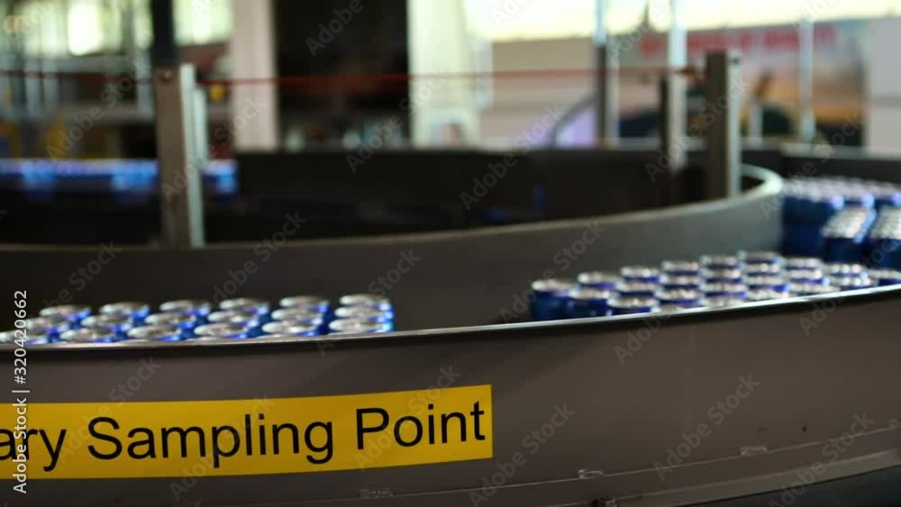 pan shot of beer blue cans boxes moving on a Belt conveyor system line, Beverage, Soda Soft drinks factory inside and bottling lines concepts pan shot of beer blue cans boxes moving on a Belt conveyor system line, Beverage, Soda Soft drinks factory inside and bottling lines concepts