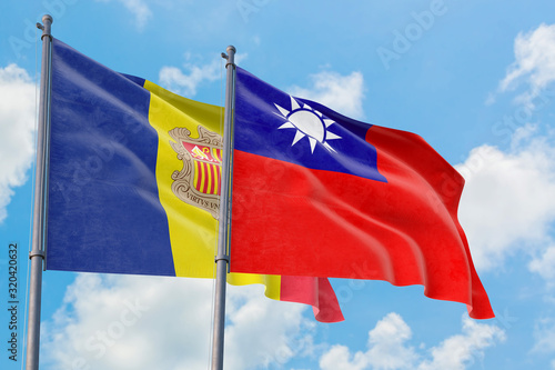 Taiwan and Andorra flags waving in the wind against white cloudy blue sky together. Diplomacy concept, international relations.