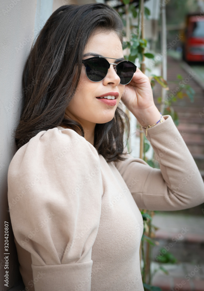 Portrait of young beautiful girl with red lips and sun glasses from middle east country Tunisia is posing to photographer and looking up. Portrait of young beautiful girl with red lips and sun glasses from middle east country Tunisia is posing to photographer and looking up.