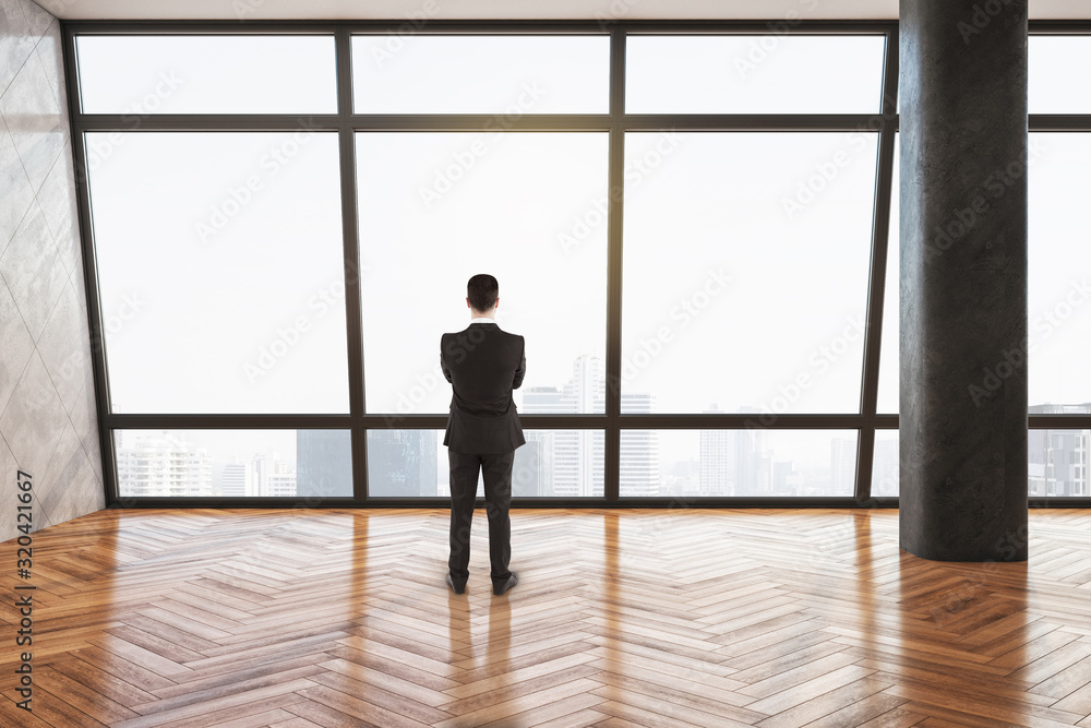 Businessman standing in gallery interior Businessman standing in gallery interior