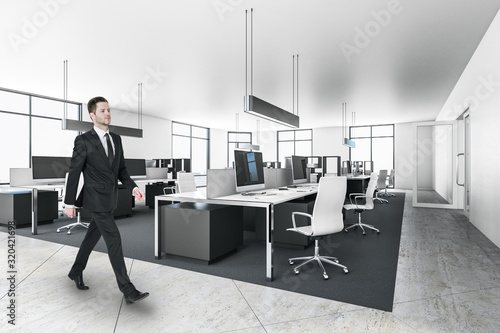 Businessman in modern office interior with furniture