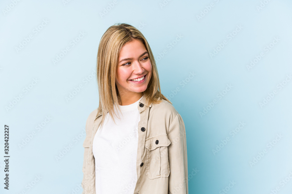 Young blonde caucasian woman isolated looks aside smiling, cheerful and pleasant. Young blonde caucasian woman isolated looks aside smiling, cheerful and pleasant.