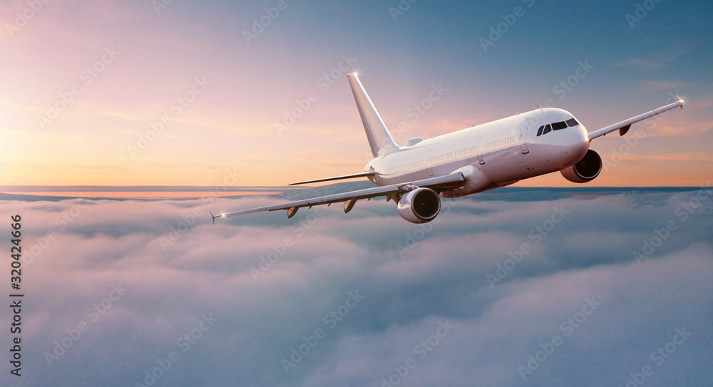 Commercial airplane jetliner flying above dramatic clouds in beautiful sunset light. Travel concept. - obrazy, fototapety, plakaty 