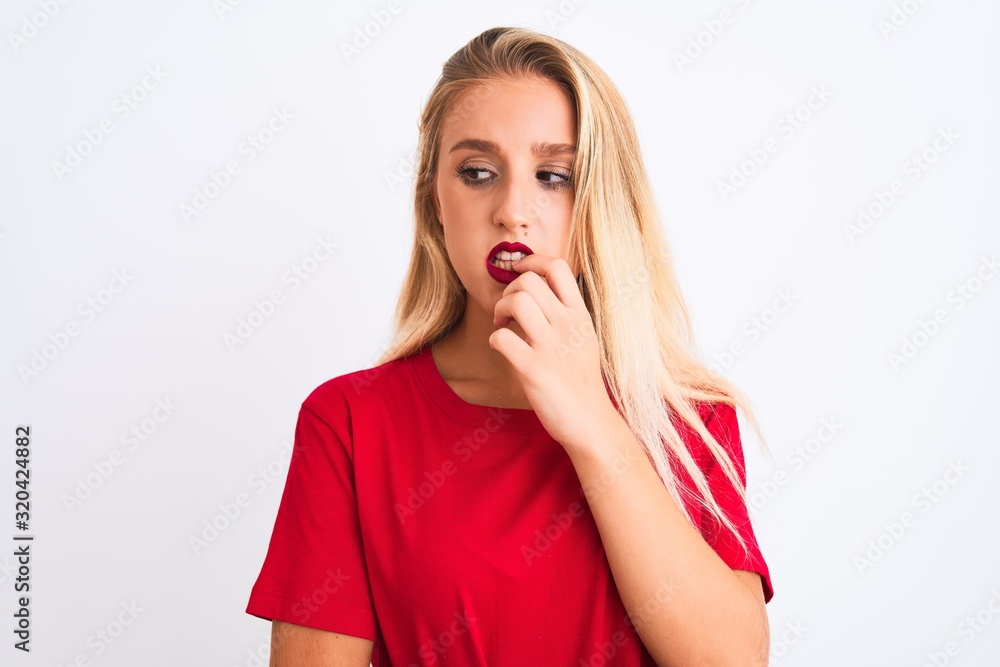 Young beautiful woman wearing red casual t-shirt standing over isolated white background looking stressed and nervous with hands on mouth biting nails. Anxiety problem. Young beautiful woman wearing red casual t-shirt standing over isolated white background looking stressed and nervous with hands on mouth biting nails. Anxiety problem.