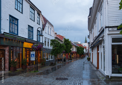 STAVANGER, NORWAY, july, 2019 : street with Traditional wooden houses in Gamle Stavanger. Gamle Stavanger is a historic area of the city center of Stavanger. Rainy moody day. Travel and