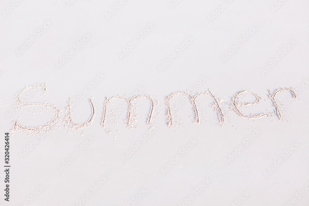 Word Summer handwritten on sandy beach with soft ocean wave on background Word Summer handwritten on sandy beach with soft ocean wave on background