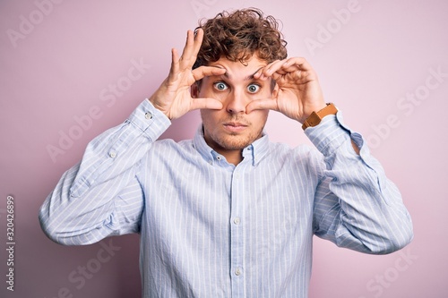 Φωτογραφία Young blond handsome man with curly hair wearing striped shirt over white backgr