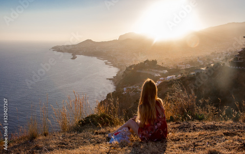 Sunset view person hiking madeira miradouro looking over bay of Funchal outdoor traveling concept photo
