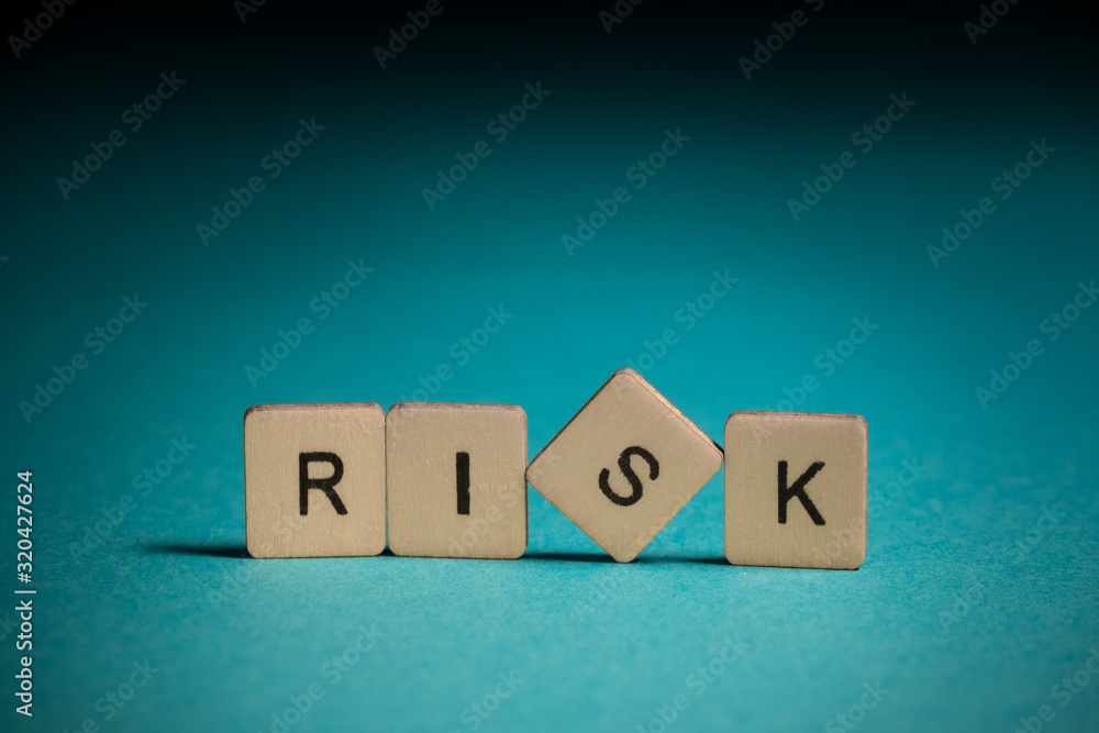 Risk: square wooden letters on a blue background Risk: square wooden letters on a blue background