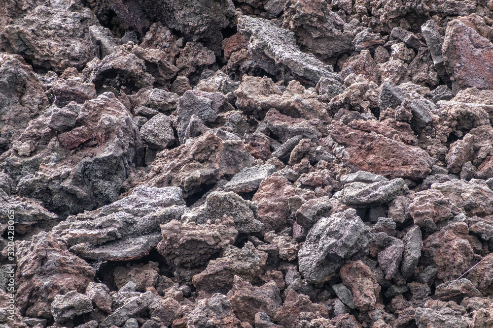 Leilani Estate, Hawaii, USA. - January 14, 2020: 2018 Kilauea volcano eruption hardened black lava field. Closeup of smaller rocks and pebbles on top. Leilani Estate, Hawaii, USA. - January 14, 2020: 2018 Kilauea volcano eruption hardened black lava field. Closeup of smaller rocks and pebbles on top.