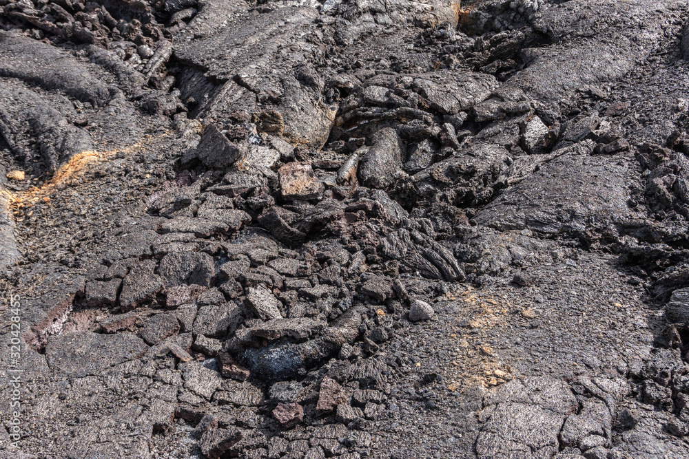 Leilani Estate, Hawaii, USA. - January 14, 2020: 2018 Kilauea volcano eruption hardened black lava field. Closeup of cracked folds of crust.