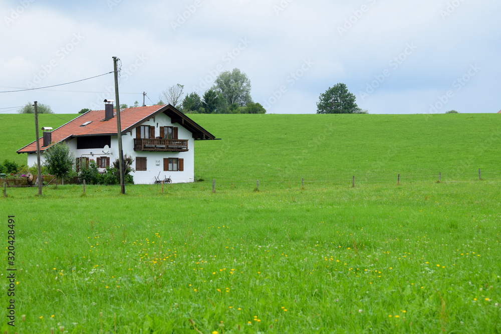 Baviera / Germany - July 28, 2019: Farmhouse in a green field
