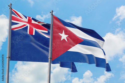 Cuba and Anguilla flags waving in the wind against white cloudy blue sky together. Diplomacy concept, international relations. photo