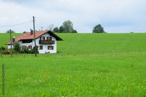 Baviera / Germany - July 28, 2019: Farmhouse in a green field