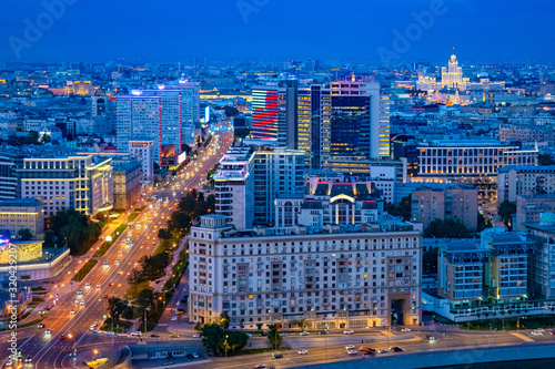 Moscow. Russia. Night panorama of Moscow. Capital aerial view. Lights of evening Moscow from a quadcopter. Roads of Russia. Cars drive through the Russian city. Travels in the Russian Federation.