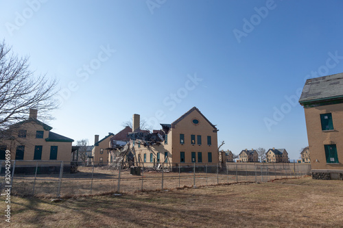 A view of some of the dilapidated buildings at Fort Hancock in Sandy Hook, New Jersey. Officers Row can be seen in the background.