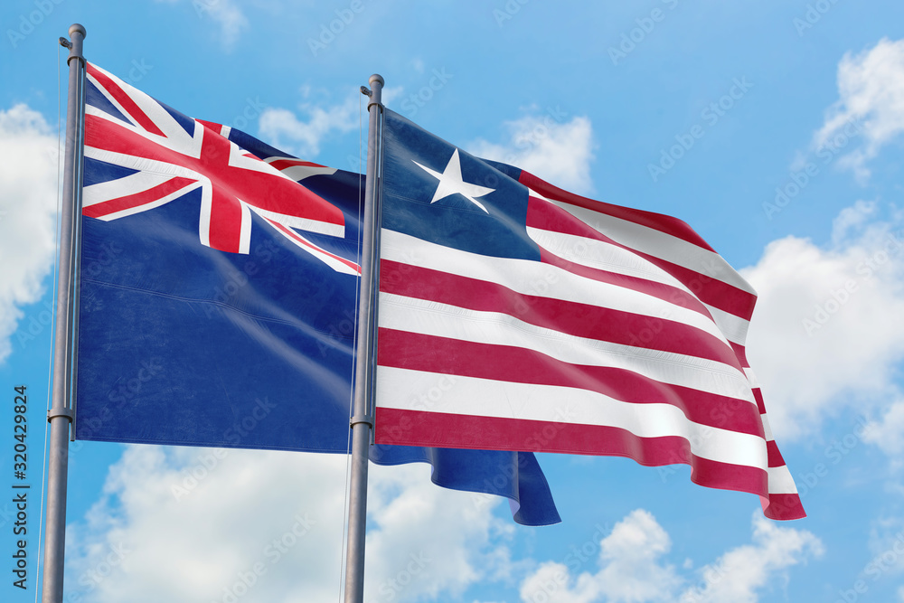 Liberia and Anguilla flags waving in the wind against white cloudy blue sky together. Diplomacy concept, international relations. Liberia and Anguilla flags waving in the wind against white cloudy blue sky together. Diplomacy concept, international relations.