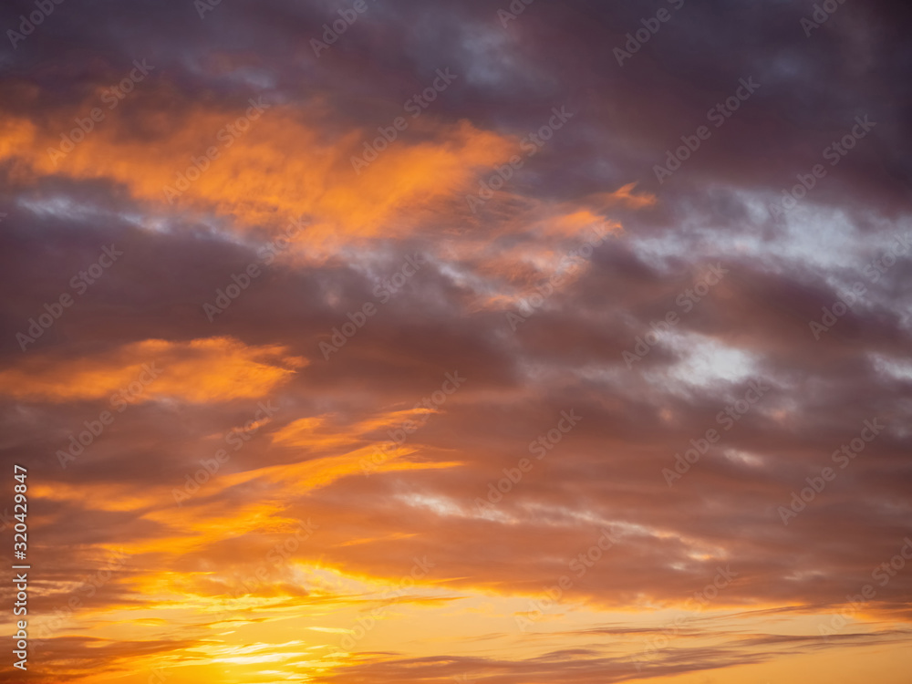 Rich colorful sunset sky. Orange and purple color. Natural abstract background.