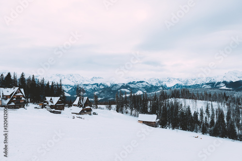 Landscape of mountain village around forest. Snow, clouds. Winter time. Slovakia