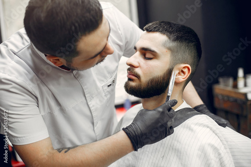 Man with a beard. Hairdresser with a client.