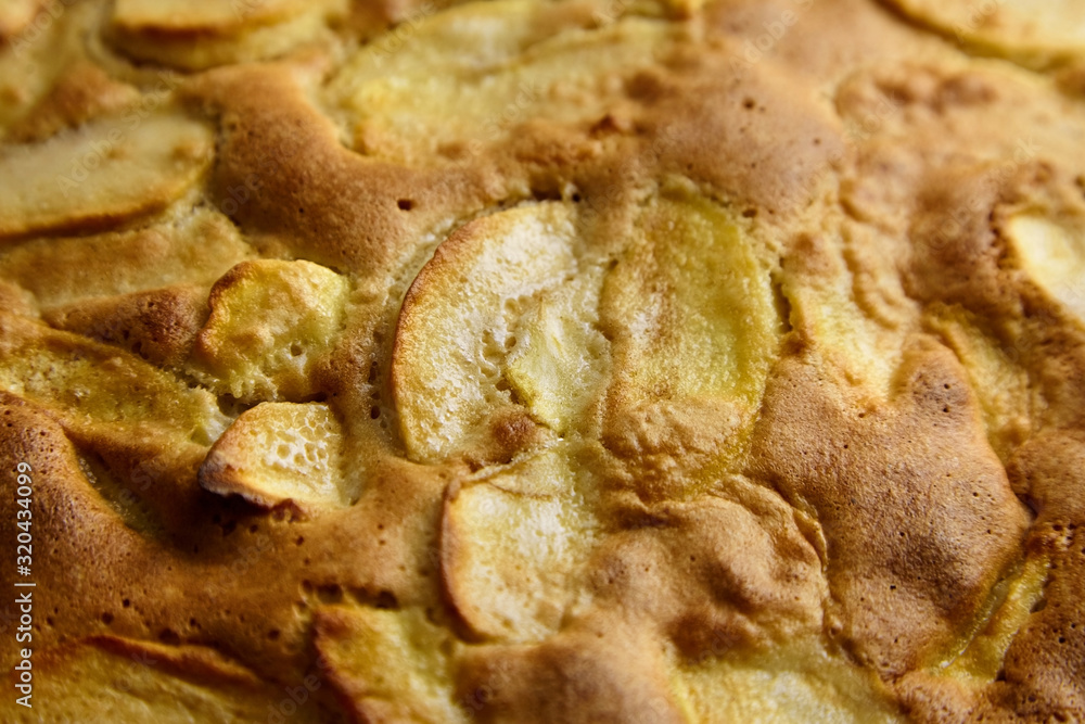 Apple pie, dessert from stewed fruits, closeup, texture, background. Charlotte, homemade baking Apple pie, dessert from stewed fruits, closeup, texture, background. Charlotte, homemade baking