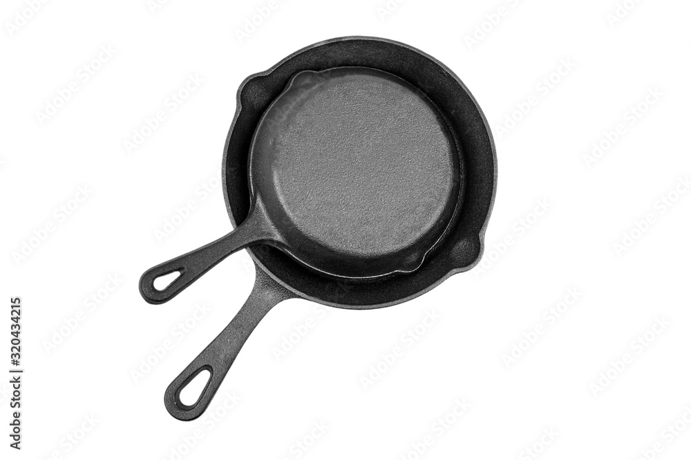 Cast iron pans isolated on white background, top view. Two black empty skillets. Kitchen equipment, cookware Cast iron pans isolated on white background, top view. Two black empty skillets. Kitchen equipment, cookware