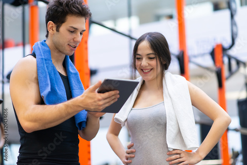 Woman talking to her personal trainer in a gym