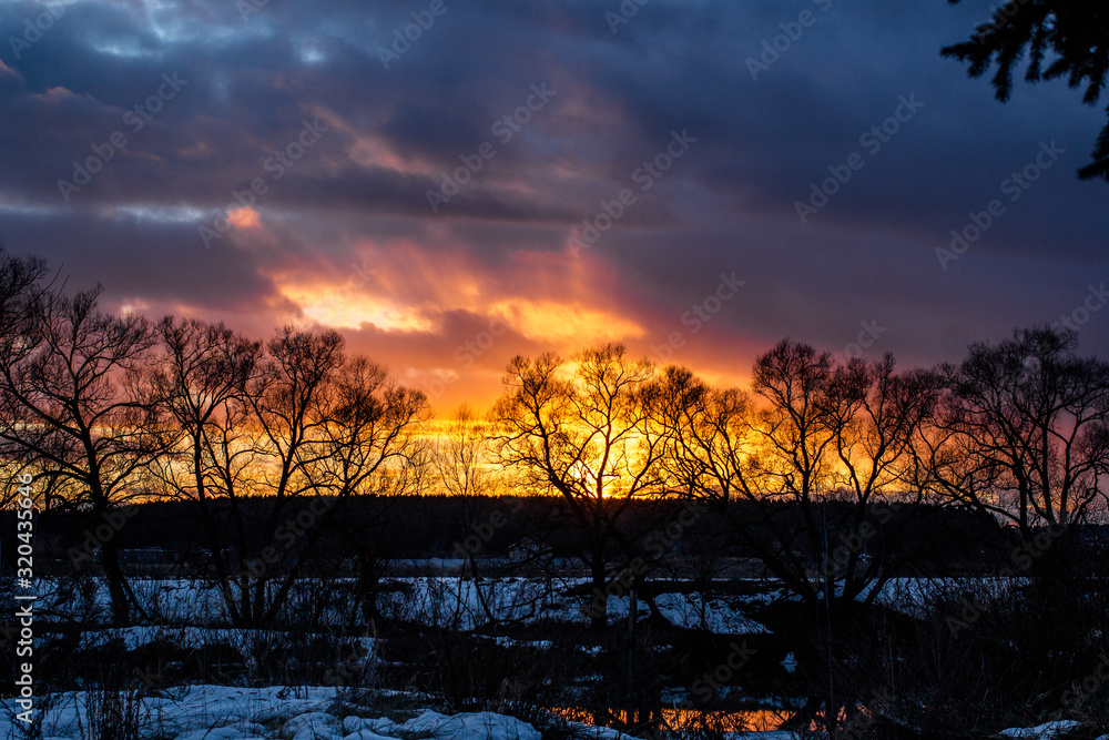 Yellow-red rays of the sun in the sky during sunset Yellow-red rays of the sun in the sky during sunset