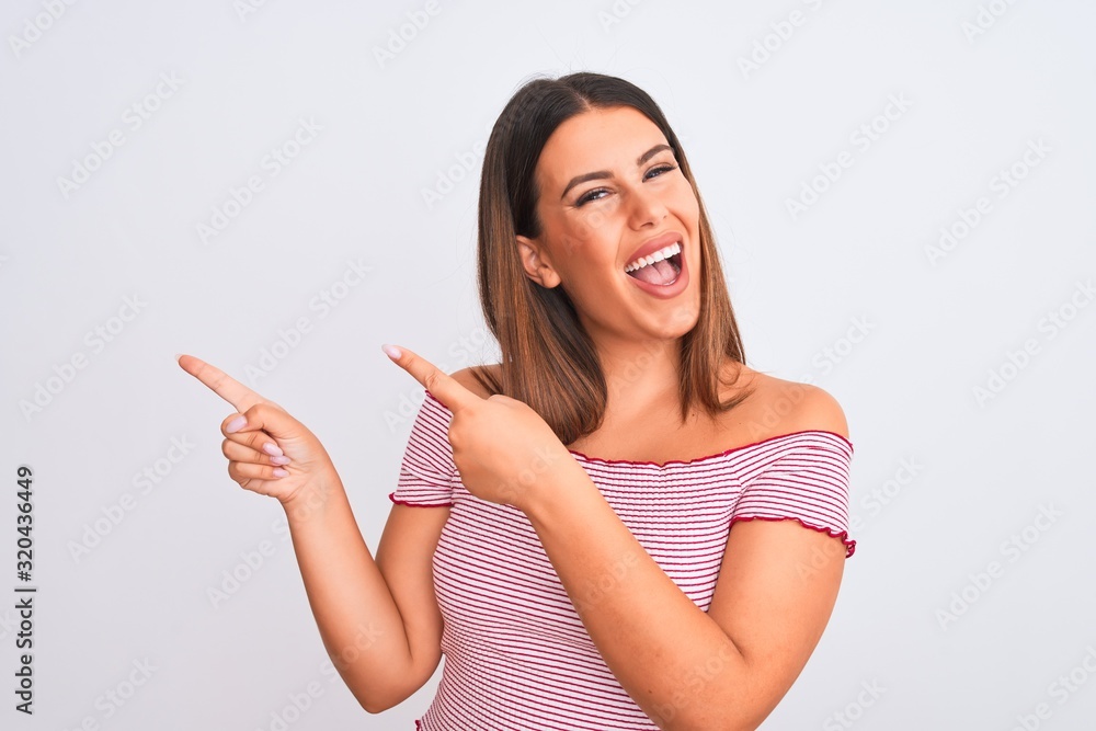Portrait of beautiful young woman standing over isolated white background smiling and looking at the camera pointing with two hands and fingers to the side. Portrait of beautiful young woman standing over isolated white background smiling and looking at the camera pointing with two hands and fingers to the side.