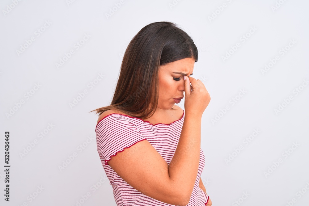 Portrait of beautiful young woman standing over isolated white background tired rubbing nose and eyes feeling fatigue and headache. Stress and frustration concept. Portrait of beautiful young woman standing over isolated white background tired rubbing nose and eyes feeling fatigue and headache. Stress and frustration concept.