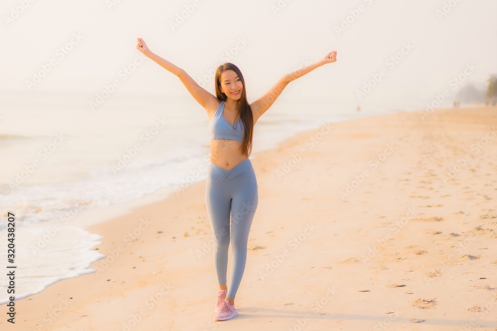 Portrait sport young asian woman prepare exercise or run on the beach sea ocean Portrait sport young asian woman prepare exercise or run on the beach sea ocean