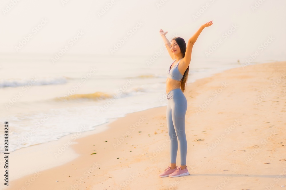Portrait sport young asian woman prepare exercise or run on the beach sea ocean Portrait sport young asian woman prepare exercise or run on the beach sea ocean