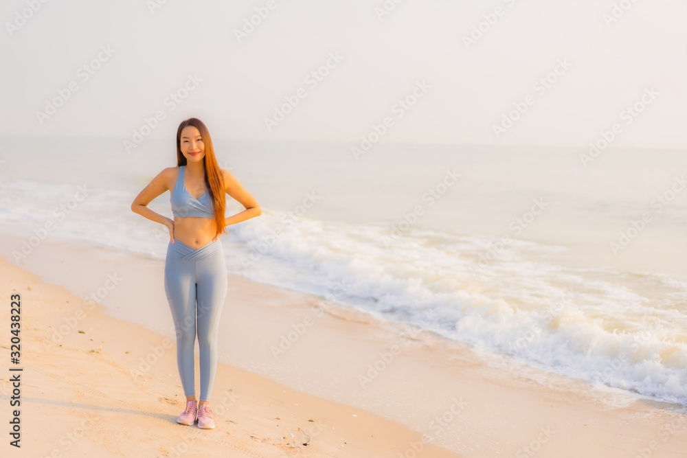 Portrait sport young asian woman prepare exercise or run on the beach sea ocean Portrait sport young asian woman prepare exercise or run on the beach sea ocean