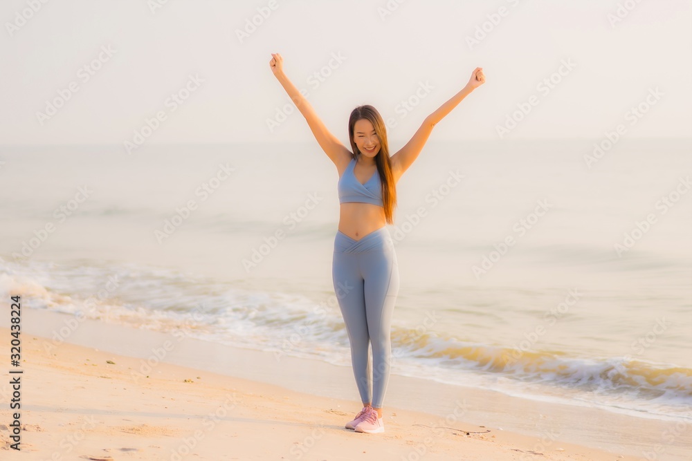 Portrait sport young asian woman prepare exercise or run on the beach sea ocean Portrait sport young asian woman prepare exercise or run on the beach sea ocean