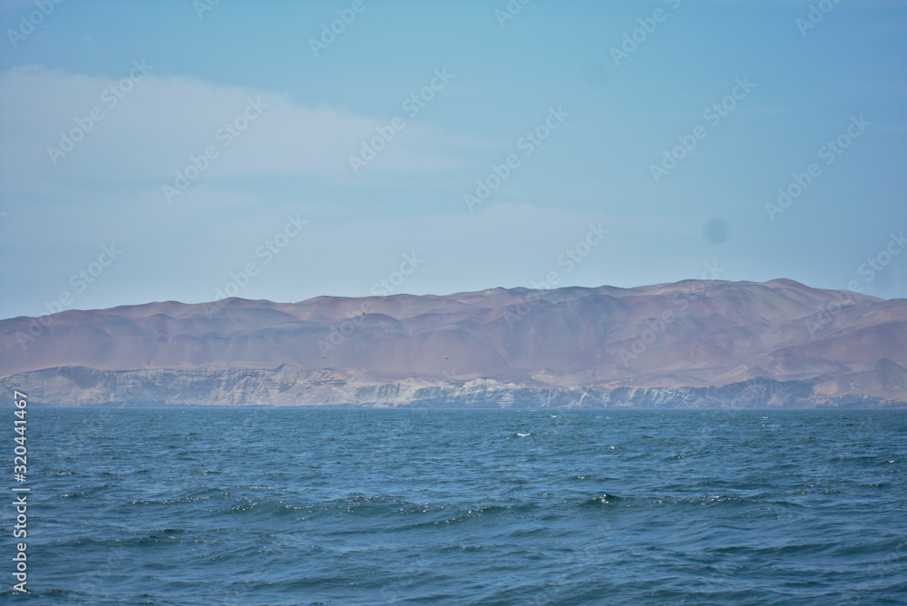 Ocean landscape with a sandy mountain in the background in Paracas Peru Ocean landscape with a sandy mountain in the background in Paracas Peru