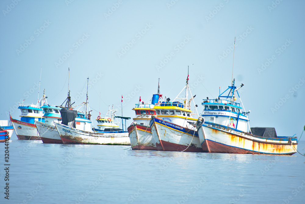 Many Colorful fishing boats floating in the ocean in Paracas Peru