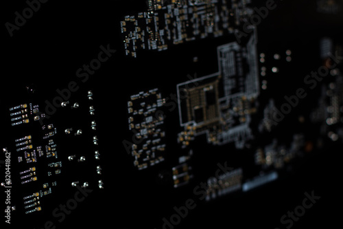 Modern printed circuit board  electronic circuit board  textolite. Black background  isolated.