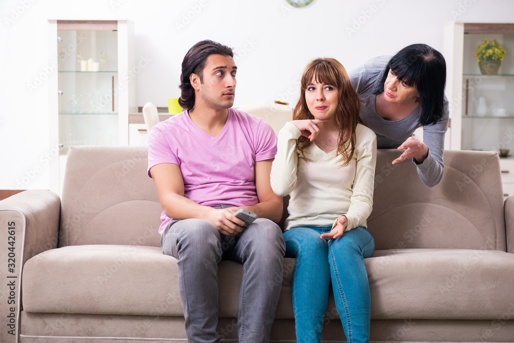 Young family and mother-in-law in family issues concept Young family and mother-in-law in family issues concept