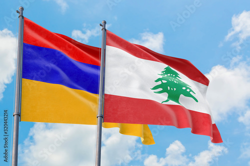 Lebanon and Armenia flags waving in the wind against white cloudy blue sky together. Diplomacy concept  international relations.