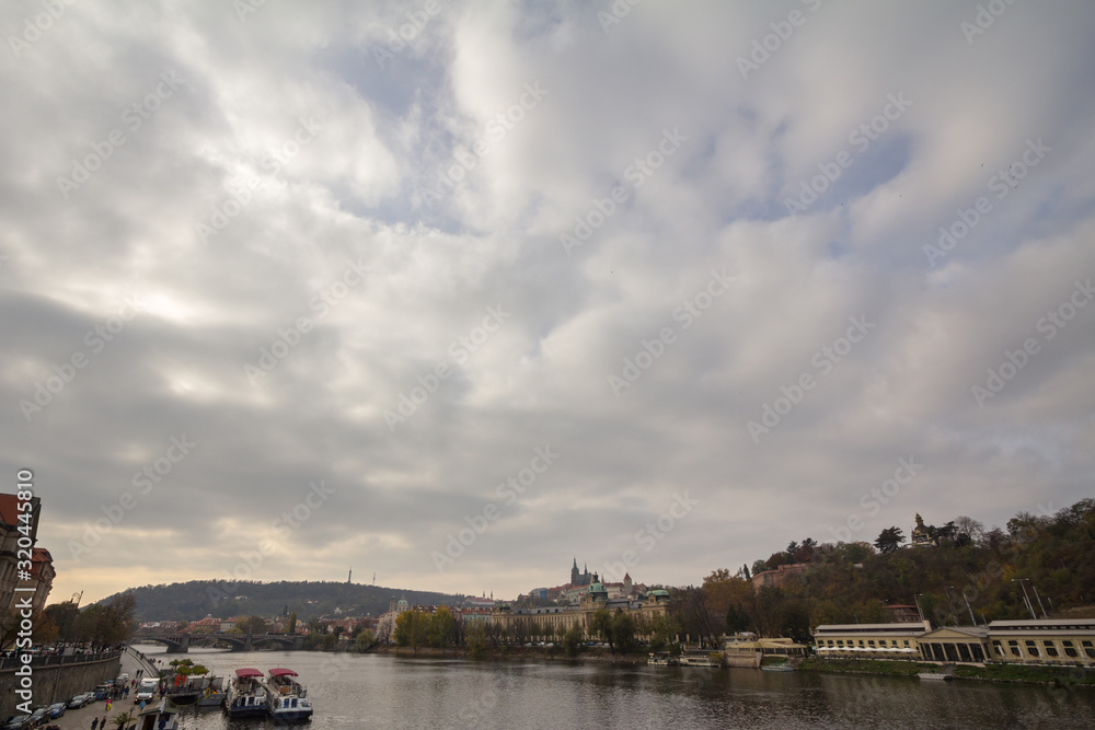 Fototapeta premium Panorama of the Old Town of Prague, Czech Republic, on the Prague Castle (Prazsky hrad) seen from the Vltava river. The castle is the main touristic landmark of the city