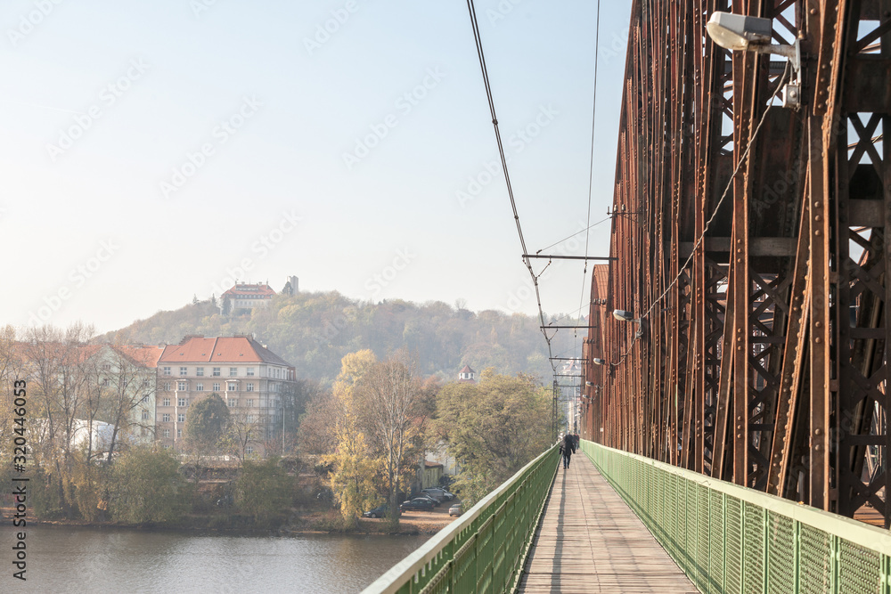 Obraz premium Vysehrad Railway bridge, also called vysehradsky zeleznicni most, in Prague, Czech Republic. It is a metal steel bridge for train transportation in Vyton district over Vltava river