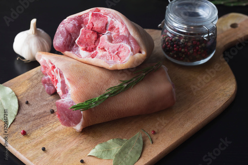raw pork knuckle with spices on a cutting board