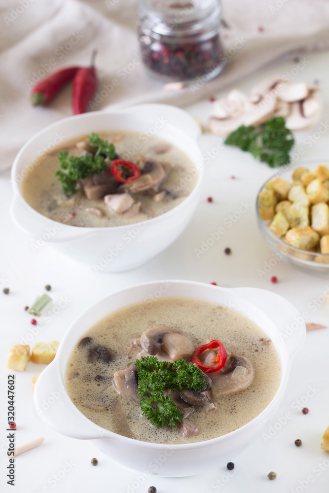 mushroom soup in a white plate and crackers mushroom soup in a white plate and crackers