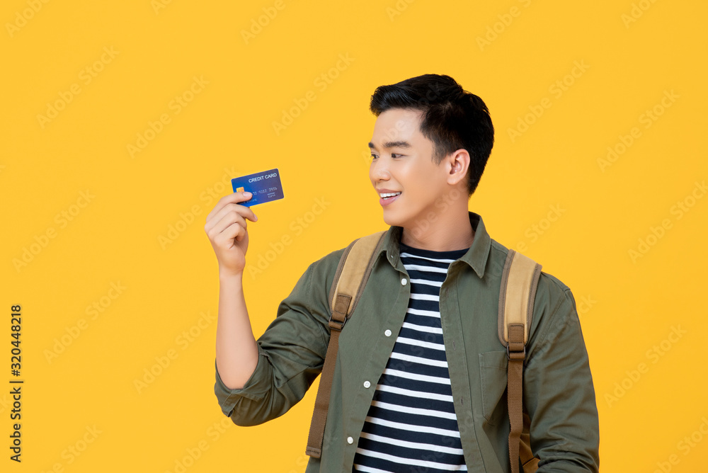 Young Asian tourist man holding credit card Young Asian tourist man holding credit card