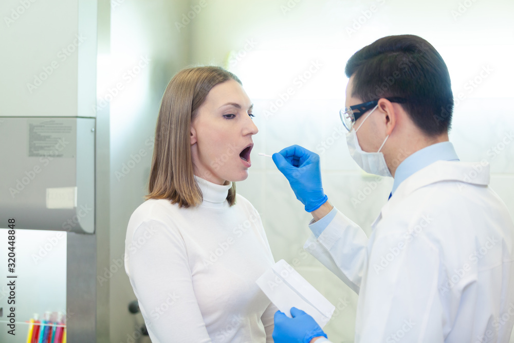 Fototapeta premium Laboratory worker performing DNA paternity test in a medical laboratory. Implementation of DNA sampling in humans