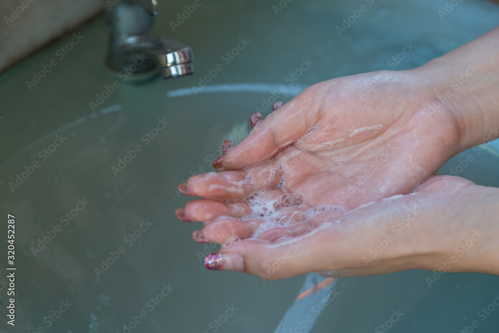 Women wash their hands properly before eating with water tap Women wash their hands properly before eating with water tap