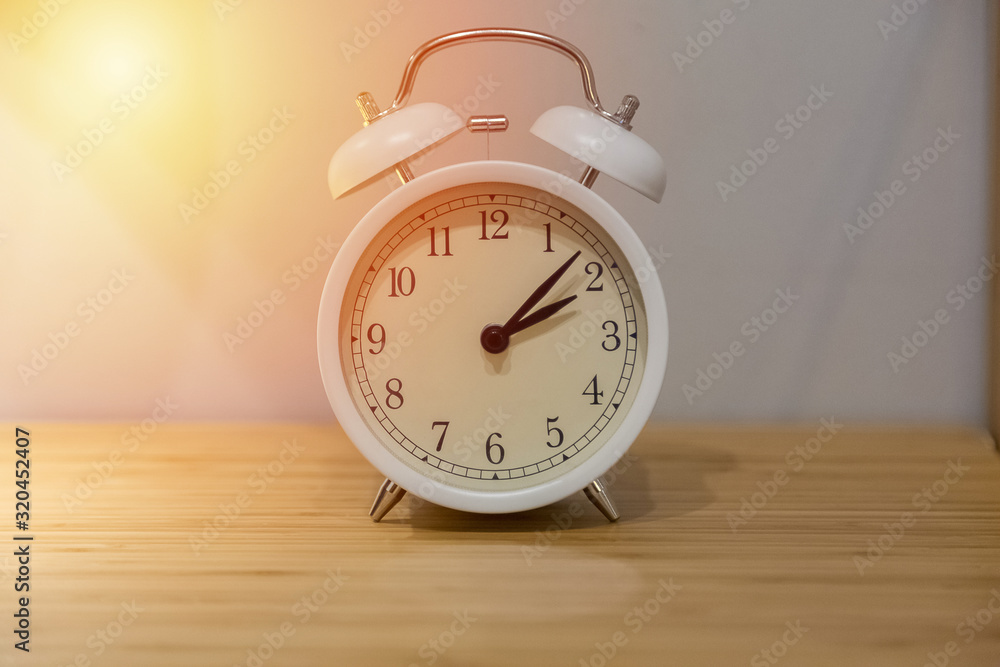 Alarm clock on the wood table beside the bed Alarm clock on the wood table beside the bed